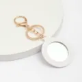 Porte-clés miroir de poche en cuir rond avec fermoir doré, accessoire cosmétique pratique. - Blanc