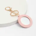 Porte-clés miroir en cuir rond rose fermoir doré charmant accessoire de sac cadeau femme. - Rose