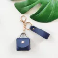 Portachiavi mini borsa in pelle PU, anello monocolore con cinturino, accessorio elegante. - Blu scuro