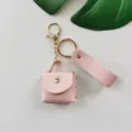 Joli porte-clés mini sac en cuir PU rose avec quincaillerie dorée et sangle élégante. - Rose