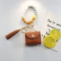 Porte-clés en perles de silicone avec mini étui en cuir et pompon, charm de sac élégant. - Bracelet avec Goutte / Café