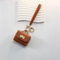 Mini etui pour ecouteurs en cuir marron avec serrure, porte-cles et petit porte-monnaie. - Marron