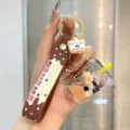 Cute cartoon liquid milk tea bear keychain detail shot, clear quicksand bottle pendant charm. - Coffee