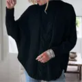Detail view of womens black cable knit turtleneck sweater with loose batwing sleeves for autumn. - S / Tops / Black