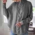 Close-up detail view of women's cozy gray cable knit turtleneck batwing sleeve sweater. - Gray
