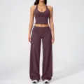 Detail view of the deep purple halter yoga top and wide-leg trousers, soft activewear fabric. - S / Top And Bottom / Eggplant Purple