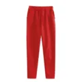Detail view of red fleece-lined sweatpants with comfortable drawstring waist and pockets. - S / Red