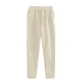 Plain beige casual sweatpants detail view with elastic drawstring waist and side pockets. - Apricot
