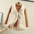 Closeup of stylish women's beige puffer vest with stand collar, quilted design and zipper. - M / Off White