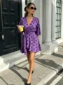 Purple polka dot V-neck wrap dress outdoor street style detail view fashion apparel. - Purple