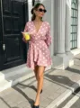 Elegant pink polka dot wrap mini dress detail, featuring a flattering V-neck and high waist. - S / Pink
