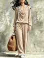 Detailed view of the stylish beige velvet cowl neck top and pants set worn by model. - Apricot