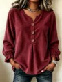 Close-up view of women's corduroy long sleeve V-neck shirt with wooden buttons detail. - Burgundy