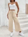 Detailed view of casual solid color drawstring loose straight-leg trousers in beige tone. - S / Off White