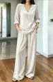 Detailed view of the elegant beige velvet V-neck long sleeve top and matching wide leg pants set. - S / Off White
