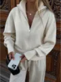 Detailed shot of a women's ribbed knit zip-up cardigan featuring a stand collar and long sleeves. - XS / Tops / Off White