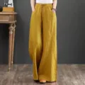 Detail shot of the vintage ramie wide-leg pants featuring a high elastic waist and pockets. - S / Bottoms / Orange