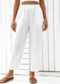 Detail view of white high-waisted casual straight leg trousers and trendy crop top set. - S / Bottoms / White