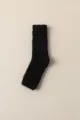 Détail de chaussette confortable en polaire corail noire, jambière chaude douce. - Taille unique / Noir
