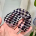 Close-up detail of a large black and white plaid U-shaped hair claw clip for elegant hairstyles. - B Geometric U-Shaped Hair Claw