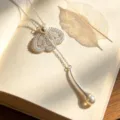 Delicate silver lace petal pearl pendant necklace detail shot, elegant aesthetic jewelry. - Necklace / Silver