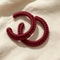 Close-up of hand-woven leather texture detail on the stylish dark red C-hoop earrings. - C Wine Red