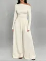 Close-up detail of the elegant off-shoulder long sleeve top and wide-leg jumpsuit outfit. - Apricot