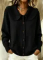 Black knit cardigan detail featuring oversized doll collar and brown button closure. - S / Tops / Black