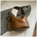 Stylish brown leather bucket bag for women, retro shoulder crossbody handbag for autumn. - With Pendant / Brown