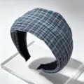 Close-up detail of Korean style pleated plaid wide headband in green and purple colors. - E Blue Orange Plaid