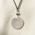 Detailed view of silver hollow geometric spiral pendant necklace with black cord and beads. - B Hollow Rhinestone Small Flower