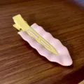 Detail shot of the pastel wavy hair clip showing its glossy pink base and cream yellow clip. - Pink Wave & Yellow Clip