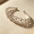 Detailed close-up of the silver woven cuff bracelet featuring clear crystal beaded lattice design. - Crystal Beaded Woven Bangle