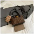 Leopard print top handle crossbody bag with cute dog pendant and metal lock. - Leopard Print Black With Pendant