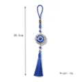 Detailed view of the blue evil eye metal pendant featuring a delicate tassel and hanging cord. - Round Tassel Style