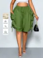 Women high-waist loose harem shorts with large pockets and stylish drawstring detail view. - Green