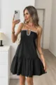 Detailed view of women's elegant black camisole dress with white scalloped trim. - Black