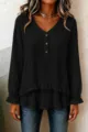 Detailed shot of the black long sleeve blouse showing the V-neck and ruffled layered hem. - Black
