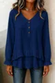Detail view of dark blue long sleeve top, featuring ruffled hem and wooden buttons. - Dark Blue