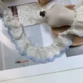 Detail shot of 5.5cm wide white ruffled lace trim with blue embroidered floral edges for crafts. - 5.5cm / Blue Edge