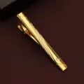 Gold metal tie clip detail shot featuring diagonal textured pattern and embedded crystal stone. - Diagonal Rhinestone Style (New602)