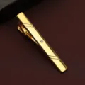 Detail view of a gold men's tie clip featuring a sparkling crystal accent and sleek striped lines. - Simple Rhinestone Style (New603)