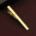 Close-up detail shot of a sleek golden men's business tie clip featuring a delicate crystal inlay. - 3D Texture Style (New604)