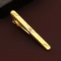 Gold tone metal tie clip for men detail view, featuring clear crystal accent and geometric lines. - Center Diamond Style (New609)