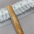 White ruffled lace trim detail with faux pearls, showcasing fabric texture and width measurement. - 8cm Wide (1 Yard) / White