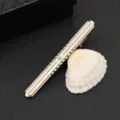 Silver metal tie clip detail view, minimalist design featuring a small crystal rhinestone accent. - Exquisite Single Rhinestone Long Bar Style (J89)
