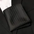 Detailed view of a black pleated men's suit pocket square, elegant formal polyester fabric. - Black Bold Stripe Style