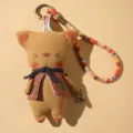 Handmade fabric animal doll keychain with plaid vest, miniature fork and colorful strap - Brown Pig