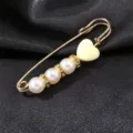 Pearl rhinestone heart safety pin brooch detail, elegant gold tone fashion jewelry accessory. - Yellow Heart Style