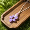 Purple resin flower pendant necklace with white braided cord, bohemian beach style jewelry. - Purple Flower